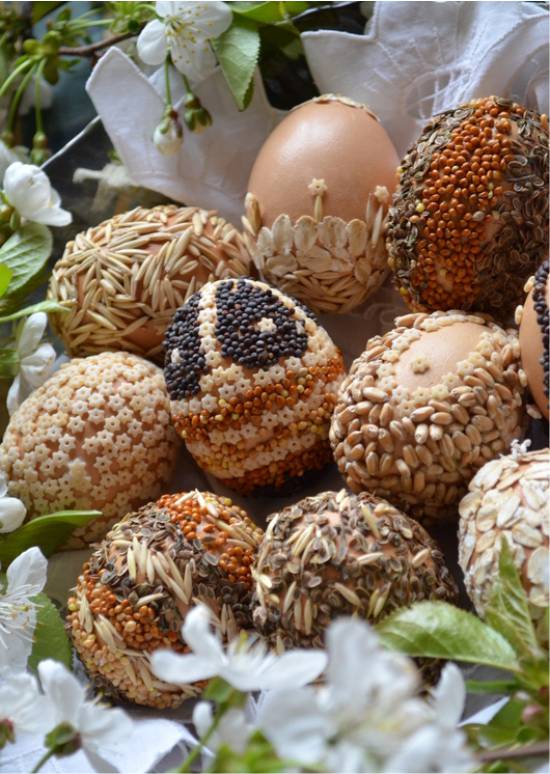 Easter eggs decor with cereals, grains and seeds