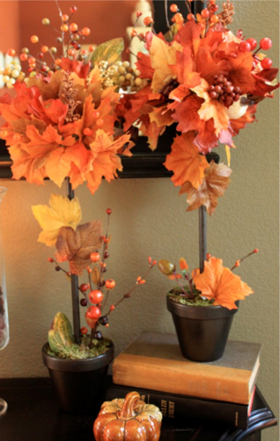 Topiary of autumn leaves and twigs with berries