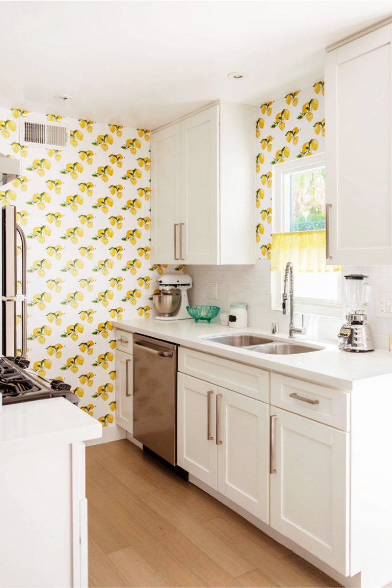 White kitchen with yellow wallpaper