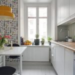 Kitchen with wallpaper on the same wall