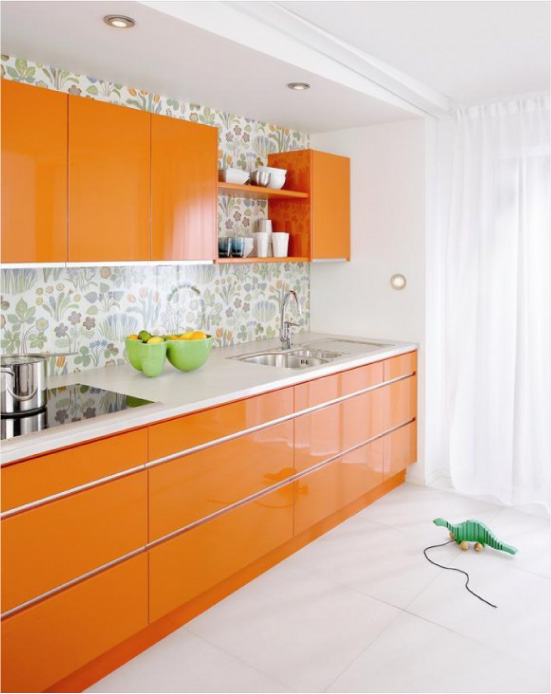 Orange glossy kitchen with green wallpaper