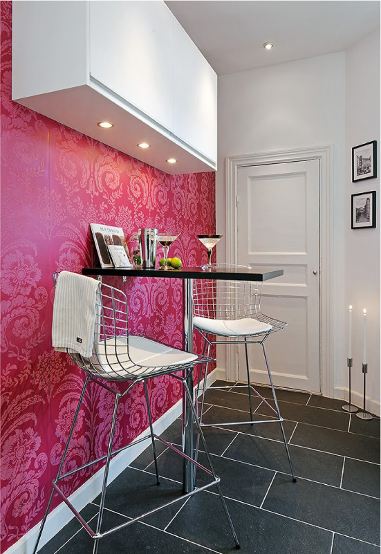 Pink wallpaper on black and white kitchen